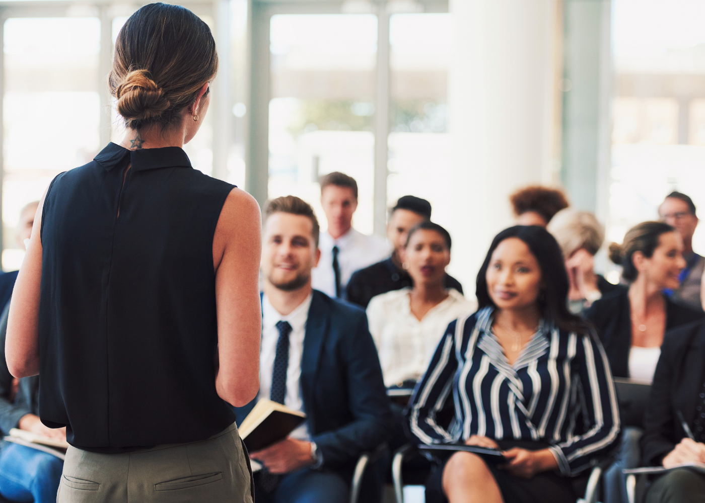 A presenter speaks to a seated group of employees.